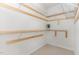 Spacious walk-in closet with custom wooden shelving, ready for effortless organization and storage at 1522 Palmer Hill Dr, Durham, NC 27703