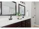 Elegant bathroom featuring double sinks, quartz countertops, dark cabinets, and modern fixtures for a luxurious feel at 163 Davelyn Ct, Garner, NC 27529