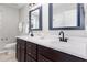 Modern bathroom featuring double sinks with granite countertops, dark wood cabinets, and stylish fixtures at 163 Davelyn Ct, Garner, NC 27529