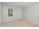 Cozy bedroom with natural light, carpet and a window providing a green view for a peaceful ambiance at 163 Davelyn Ct, Garner, NC 27529