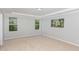 Bright bedroom with carpet, two windows offering views, and a serene artwork, creating a calming retreat at 163 Davelyn Ct, Garner, NC 27529