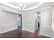 Elegant dining room featuring trey ceiling, wainscoting and hardwood floors at 163 Davelyn Ct, Garner, NC 27529