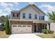 Charming two-story home with stone accents, covered porch and two car garage at 163 Davelyn Ct, Garner, NC 27529