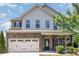 Charming two-story home with stone accents, covered porch and two car garage at 163 Davelyn Ct, Garner, NC 27529