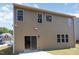 Rear exterior featuring neutral siding, a patio, and several windows providing ample natural light at 163 Davelyn Ct, Garner, NC 27529