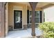 Inviting front porch with craftsman columns, black front door and stone accents at 163 Davelyn Ct, Garner, NC 27529