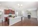 Open kitchen with large island, stainless appliances and hardwood floors at 163 Davelyn Ct, Garner, NC 27529