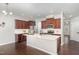 Modern kitchen with dark wood cabinets, stainless appliances, and a large center island with a white countertop at 163 Davelyn Ct, Garner, NC 27529