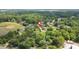 A high angle shot showcasing a house surrounded by verdant trees and other homes in the neighborhood at 1647 Turner Rd, Mebane, NC 27302