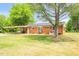 View of the home's brick exterior from the backyard showing a covered parking area at 1647 Turner Rd, Mebane, NC 27302