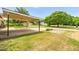 Spacious backyard featuring a covered parking area and a large grassy lawn at 1647 Turner Rd, Mebane, NC 27302