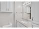 Bathroom featuring gray countertop vanity with decorative lighting and white storage cabinet at 1647 Turner Rd, Mebane, NC 27302