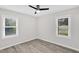 Cozy bedroom featuring light gray walls, vinyl floors and a ceiling fan at 1647 Turner Rd, Mebane, NC 27302