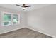 Bedroom with light gray walls, vinyl floors, ceiling fan and natural light from windows at 1647 Turner Rd, Mebane, NC 27302