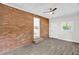 Cozy den featuring brick wall, wood-look floors, and neutral decor at 1647 Turner Rd, Mebane, NC 27302