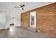 Cozy den featuring brick wall, wood-look floors, and neutral decor at 1647 Turner Rd, Mebane, NC 27302
