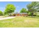 Lovely brick home with a covered parking area, surrounded by a lush lawn at 1647 Turner Rd, Mebane, NC 27302