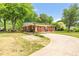 Charming brick home with a covered parking area, and a well-maintained yard at 1647 Turner Rd, Mebane, NC 27302