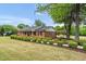 Well-maintained brick home with manicured landscaping and covered parking at 1647 Turner Rd, Mebane, NC 27302