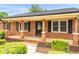 Inviting brick home with a covered front porch and well-kept landscaping at 1647 Turner Rd, Mebane, NC 27302