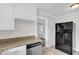 Stylish kitchen with white cabinets, granite counters, and stainless refrigerator at 1647 Turner Rd, Mebane, NC 27302