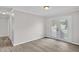 Bright living room with gray walls, white trim, wood-look floors, and patio doors at 1647 Turner Rd, Mebane, NC 27302
