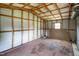The inside of a spacious storage shed with a window and exposed framing at 1647 Turner Rd, Mebane, NC 27302