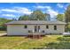 Exterior view featuring a deck overlooking a lawn and wooded scenery at 1732 Green Pace Rd, Zebulon, NC 27597