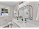 Updated bathroom featuring a white vanity, decorative mirror, and natural light at 1732 Green Pace Rd, Zebulon, NC 27597
