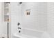 Modern bathroom with subway tile, bathtub, and convenient shelving at 1732 Green Pace Rd, Zebulon, NC 27597