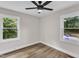 Bright, airy bedroom with wood-look floors and two windows at 1732 Green Pace Rd, Zebulon, NC 27597