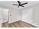 Bright bedroom featuring wood-look floors, a closet, and ceiling fan at 1732 Green Pace Rd, Zebulon, NC 27597