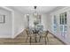Cozy dining room with stylish lighting, seating for four, and French doors to the patio at 1732 Green Pace Rd, Zebulon, NC 27597