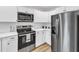 Bright kitchen with stainless appliances, white cabinets, and updated fixtures at 1732 Green Pace Rd, Zebulon, NC 27597