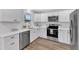 Bright kitchen with stainless appliances, white cabinets, and updated fixtures at 1732 Green Pace Rd, Zebulon, NC 27597