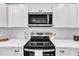 Gourmet kitchen featuring stainless steel appliances, and modern cabinetry at 1732 Green Pace Rd, Zebulon, NC 27597