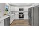 Bright kitchen featuring stainless appliances, light countertops, and hardwood floors at 1732 Green Pace Rd, Zebulon, NC 27597