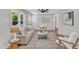 Bright living room with hardwood floors, stylish furniture, a large window, and ceiling fan at 1732 Green Pace Rd, Zebulon, NC 27597