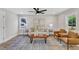 Cozy living room with hardwood floors, stylish furniture, a large window, and modern decor at 1732 Green Pace Rd, Zebulon, NC 27597