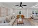 Comfortable living room with hardwood floors, light gray walls, and large windows at 1732 Green Pace Rd, Zebulon, NC 27597