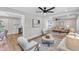 Open concept living area with hardwood floors, stylish furniture, seamlessly connecting to kitchen at 1732 Green Pace Rd, Zebulon, NC 27597