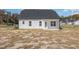 Back exterior featuring a covered patio and pristine white siding at 175 Trescott St, Smithfield, NC 27577