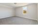 Bright bedroom with neutral carpet and walls, and a window providing natural light at 175 Trescott St, Smithfield, NC 27577