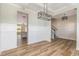 A dining room features wood flooring, wainscoting, and modern lighting, connecting spaces at 175 Trescott St, Smithfield, NC 27577