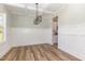 A dining room boasts modern lighting, wainscoting, and attractive wood flooring at 175 Trescott St, Smithfield, NC 27577
