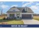 Charming two-story home featuring a gray garage door and a well-manicured front lawn at 175 Trescott St, Smithfield, NC 27577