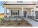 Inviting front porch with stone accents and freshly seeded front yard, offering curb appeal at 175 Trescott St, Smithfield, NC 27577