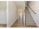 Bright hallway with hardwood floors leading to a staircase at 175 Trescott St, Smithfield, NC 27577