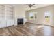 Open-concept living room with fireplace, built-in shelves, and natural light at 175 Trescott St, Smithfield, NC 27577