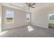 A main bedroom boasts a ceiling fan, plush carpet, and lots of natural light at 175 Trescott St, Smithfield, NC 27577